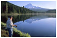 Man fishing in Trillium Lake and Mt. Hood